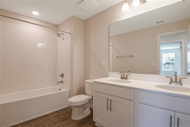 565 Summit River Dr, Apopka, FL 32712 - bathroom featuring toilet, wood tiled floors, double vanity, and tub / shower combination