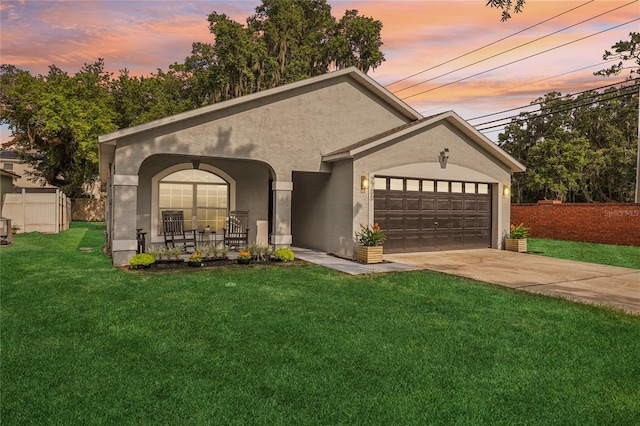 2700 Palm Isle Way, Orlando, FL 32829 - view of front of home featuring a garage, stucco siding, concrete driveway, and covered porch