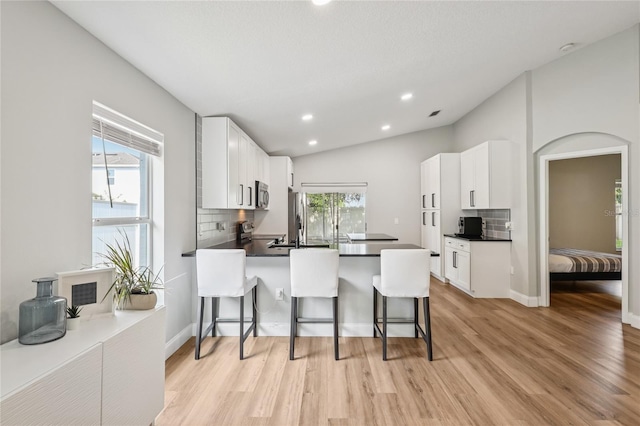 2700 Palm Isle Way, Orlando, FL 32829 - kitchen with appliances with stainless steel finishes, decorative backsplash, light wood-type flooring, and recessed lighting