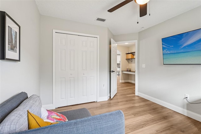 2700 Palm Isle Way, Orlando, FL 32829 - sitting room featuring wood finished floors, a ceiling fan, and baseboards