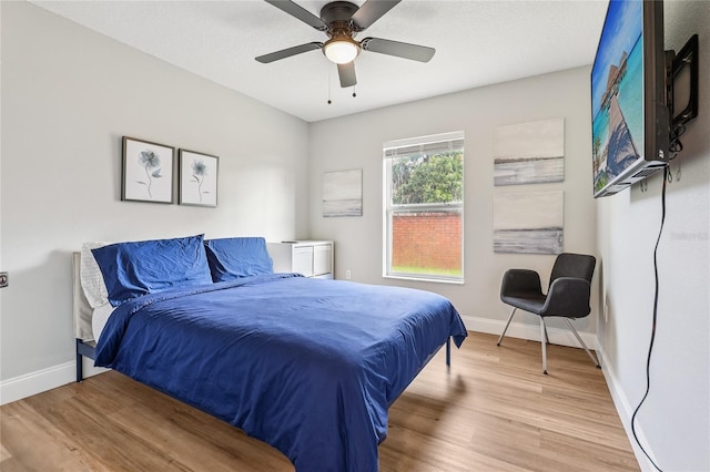 2700 Palm Isle Way, Orlando, FL 32829 - bedroom featuring baseboards, light wood-style flooring, and ceiling fan