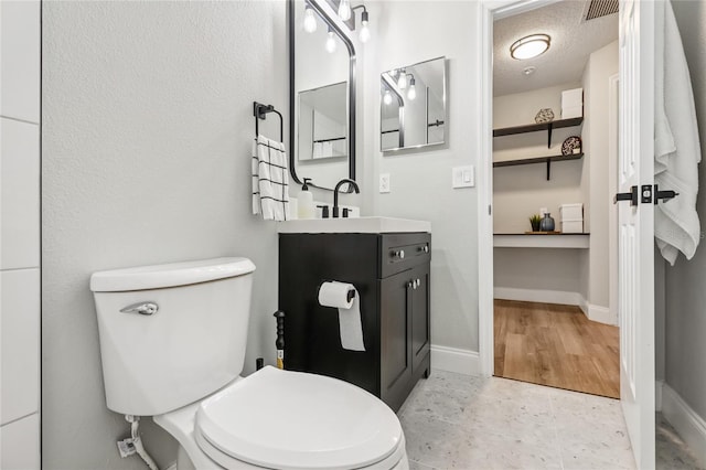 2700 Palm Isle Way, Orlando, FL 32829 - bathroom featuring vanity, toilet, and baseboards
