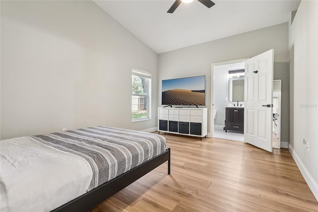 2700 Palm Isle Way, Orlando, FL 32829 - bedroom with baseboards, light wood-style floors, high vaulted ceiling, ensuite bath, and a ceiling fan