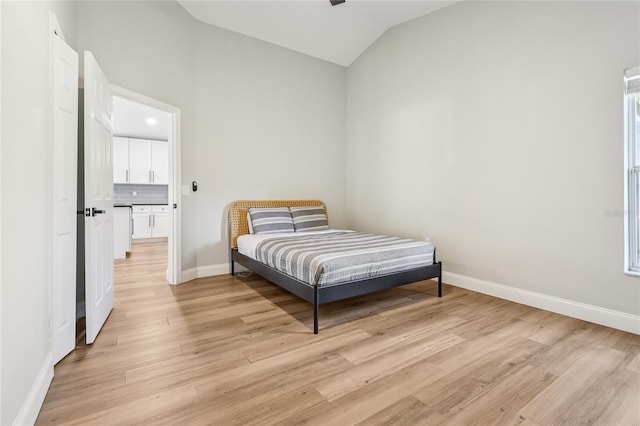 2700 Palm Isle Way, Orlando, FL 32829 - bedroom featuring lofted ceiling, light wood-style flooring, and baseboards