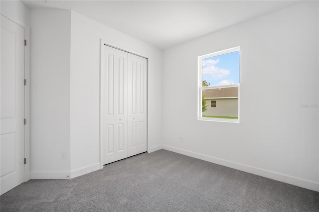 9127 Players Dr, Weeki Wachee, FL 34613 - unfurnished bedroom featuring carpet floors and a closet