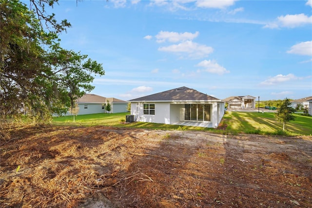 9127 Players Dr, Weeki Wachee, FL 34613 - rear view of house with a lawn and stucco siding