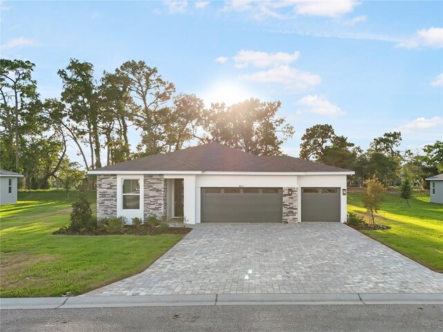 9127 Players Dr, Weeki Wachee, FL 34613 - view of front of home with stone siding, a garage, a front yard, and decorative driveway