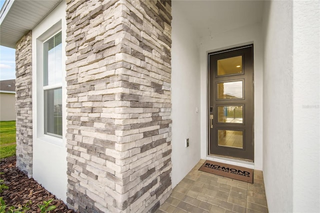9127 Players Dr, Weeki Wachee, FL 34613 - doorway to property featuring stucco siding