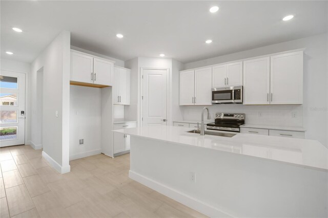 9127 Players Dr, Weeki Wachee, FL 34613 - kitchen featuring appliances with stainless steel finishes, white cabinetry, recessed lighting, light countertops, and backsplash