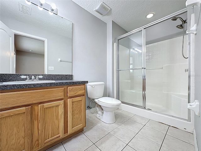 350 Scrub Jay Way, Davenport, FL 33896 - full bathroom with a stall shower, toilet, vanity, tile patterned floors, and a textured ceiling