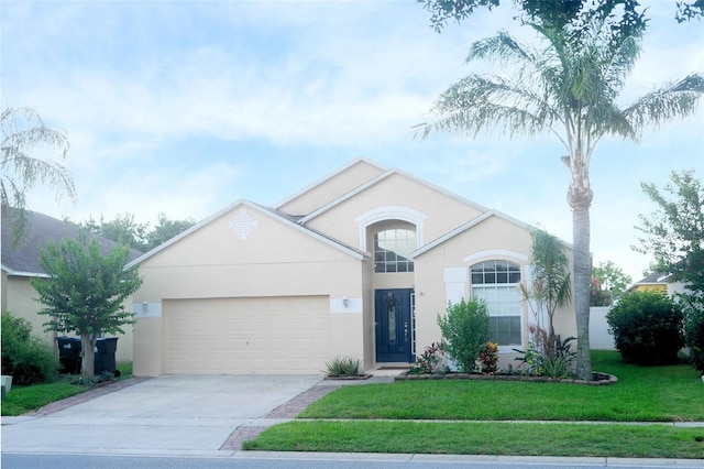 2268 Victoria Falls Dr, Orlando, FL 32824 - view of front of home with an attached garage, concrete driveway, stucco siding, and a front yard
