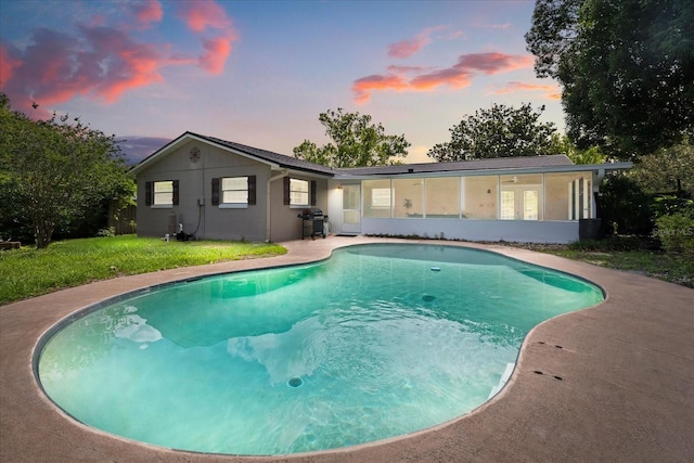 736 Forest Glen Ct, Maitland, FL 32751 - rear view of property with a sunroom, an outdoor pool, and a lawn