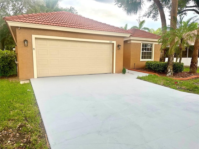 1084 Aspri Way, Riviera Beach, FL 33418 - mediterranean / spanish-style home with concrete driveway, stucco siding, an attached garage, and a tile roof