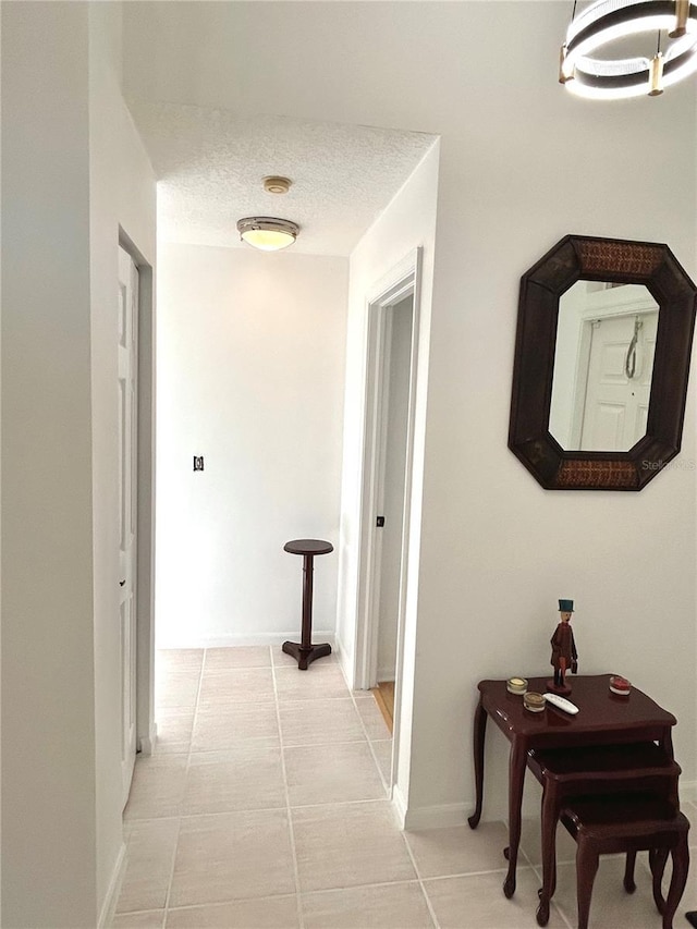 1084 Aspri Way, Riviera Beach, FL 33418 - hall with light tile patterned floors, baseboards, and a textured ceiling