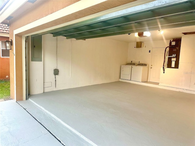 1084 Aspri Way, Riviera Beach, FL 33418 - garage featuring washer and clothes dryer, electric panel, and a garage door opener