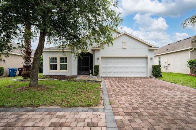 205 Lakeshore Dr, Davenport, FL 33837 - view of front of house featuring decorative driveway, a garage, stucco siding, and a front yard