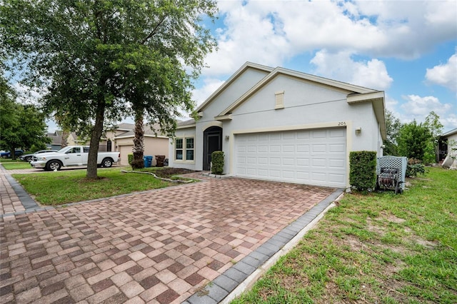 205 Lakeshore Dr, Davenport, FL 33837 - view of front of house featuring decorative driveway, a front yard, stucco siding, and a garage