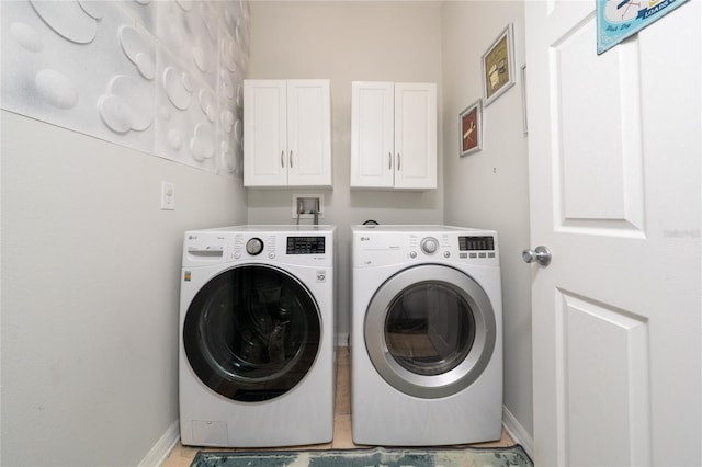 205 Lakeshore Dr, Davenport, FL 33837 - laundry area featuring washer and clothes dryer, baseboards, and cabinet space