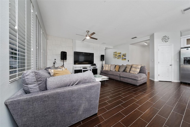 205 Lakeshore Dr, Davenport, FL 33837 - living room with ceiling fan, baseboards, and dark wood-style flooring