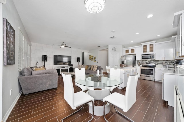 205 Lakeshore Dr, Davenport, FL 33837 - dining area featuring ceiling fan, wood tiled floors, recessed lighting, and baseboards