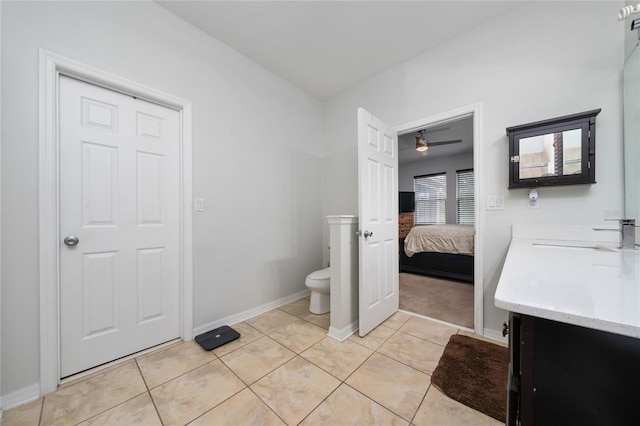 205 Lakeshore Dr, Davenport, FL 33837 - ensuite bathroom featuring vanity, toilet, ceiling fan, baseboards, and tile patterned floors