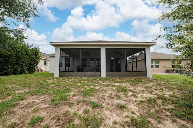 205 Lakeshore Dr, Davenport, FL 33837 - rear view of house with a sunroom, ceiling fan, stucco siding, and a lawn