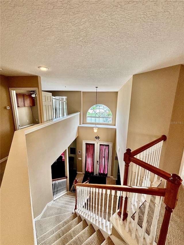 4368 Fox Glen Loop, Kissimmee, FL 34746 - entrance foyer with a textured ceiling, stairway, and baseboards