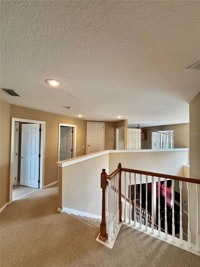 4368 Fox Glen Loop, Kissimmee, FL 34746 - hallway featuring an upstairs landing, a textured ceiling, carpet flooring, baseboards, and recessed lighting
