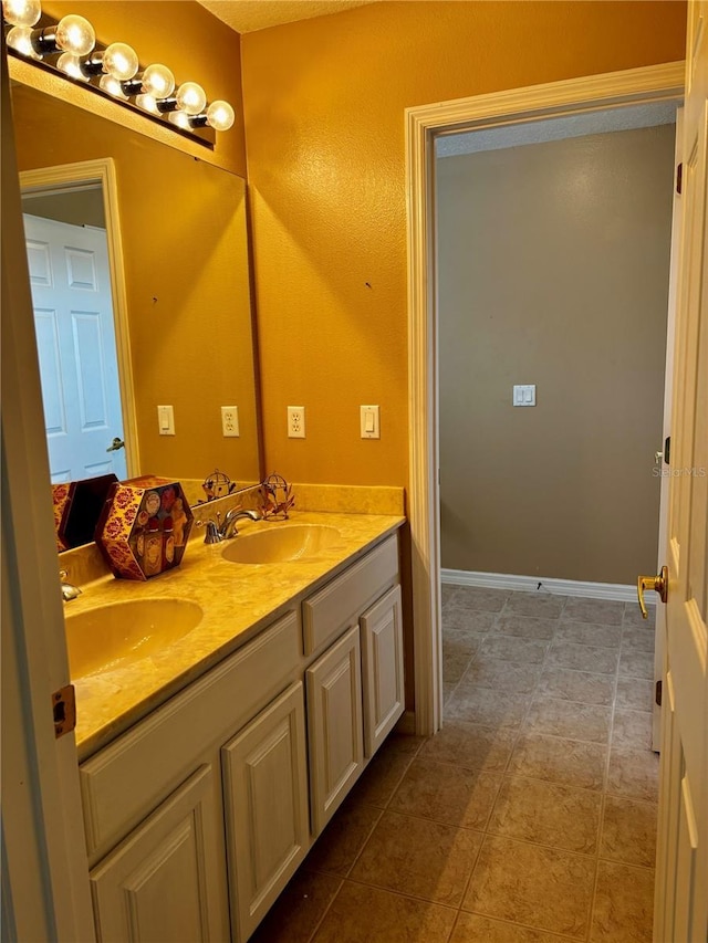 4368 Fox Glen Loop, Kissimmee, FL 34746 - bathroom with double vanity, tile patterned flooring, and baseboards