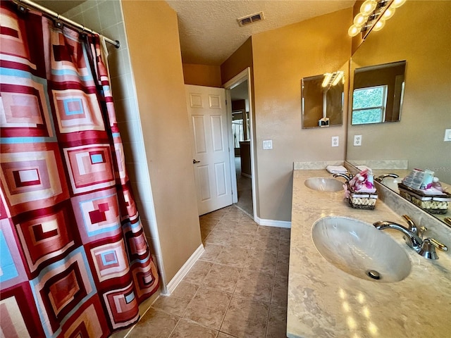 4368 Fox Glen Loop, Kissimmee, FL 34746 - bathroom with tile patterned floors, double vanity, a shower with shower curtain, a textured ceiling, and baseboards