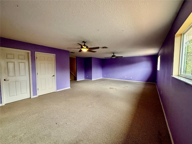 4368 Fox Glen Loop, Kissimmee, FL 34746 - unfurnished living room featuring a ceiling fan, carpet floors, a textured ceiling, and baseboards