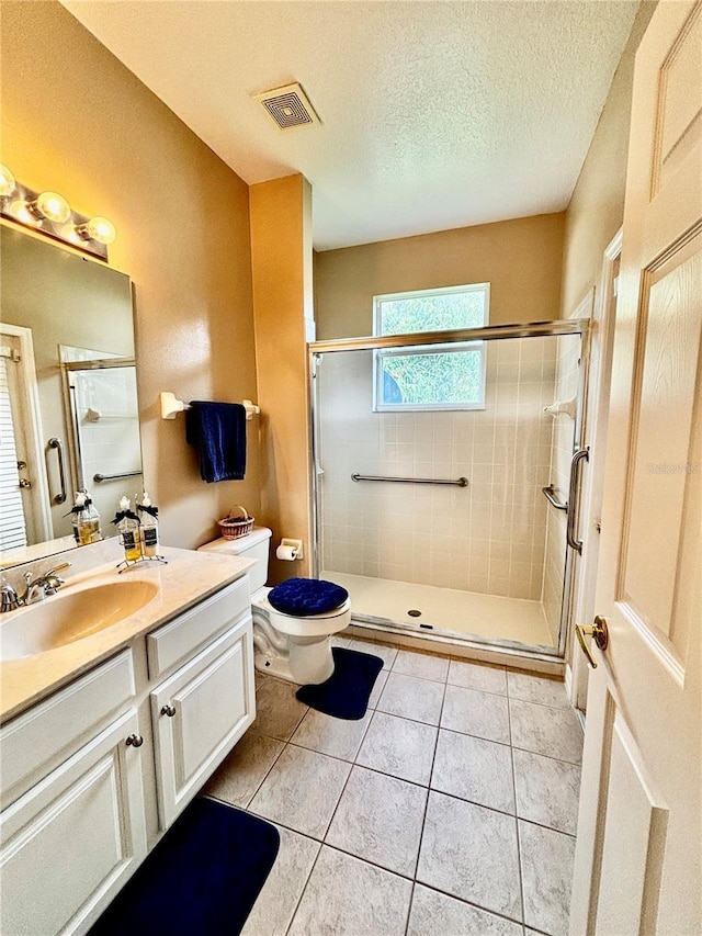 4368 Fox Glen Loop, Kissimmee, FL 34746 - bathroom with toilet, vanity, a stall shower, tile patterned flooring, and a textured ceiling
