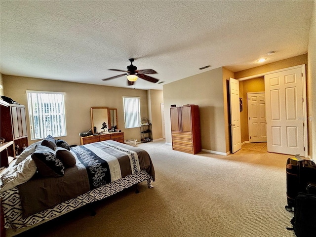4368 Fox Glen Loop, Kissimmee, FL 34746 - bedroom with multiple windows, light colored carpet, baseboards, a ceiling fan, and a textured ceiling