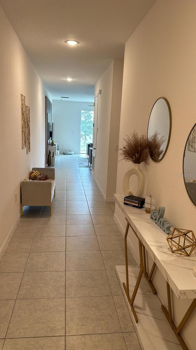 522 Feltrim Manor Rd, Haines City, FL 33844 - hallway with light tile patterned floors and baseboards
