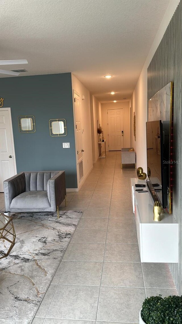 522 Feltrim Manor Rd, Haines City, FL 33844 - hallway with a textured ceiling and light tile patterned floors