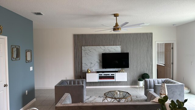 522 Feltrim Manor Rd, Haines City, FL 33844 - living room with tile patterned floors, ceiling fan, a textured ceiling, and baseboards