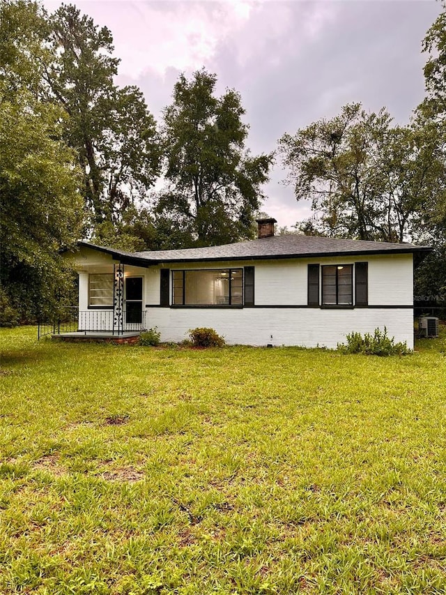 1615 NE 9th St, Ocala, FL 34470 - single story home featuring a front yard, cooling unit, and a chimney
