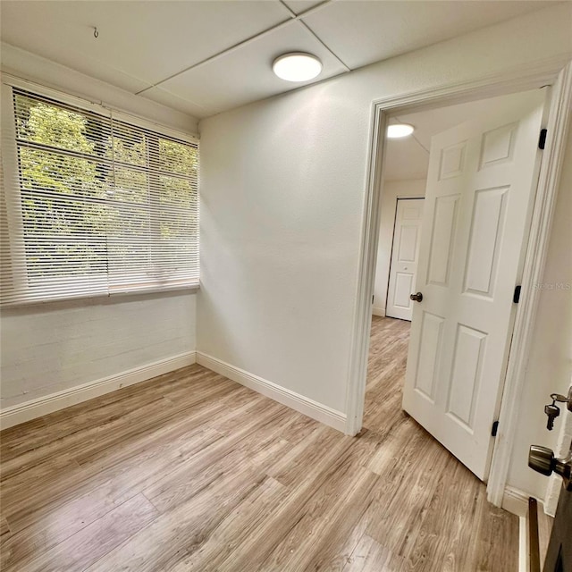 1615 NE 9th St, Ocala, FL 34470 - spare room with baseboards and light wood-type flooring