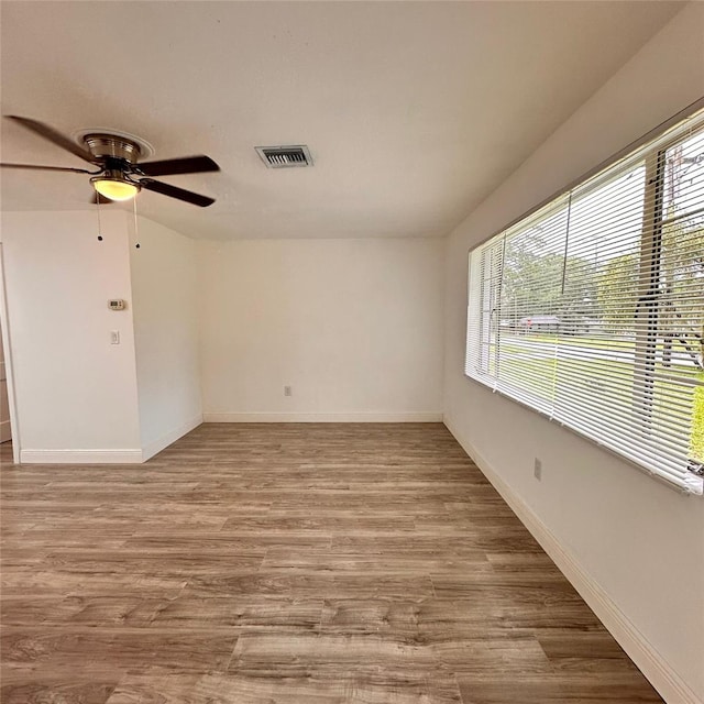 1615 NE 9th St, Ocala, FL 34470 - spare room featuring ceiling fan, wood finished floors, and baseboards