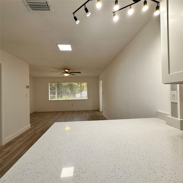 1615 NE 9th St, Ocala, FL 34470 - unfurnished room featuring ceiling fan, wood finished floors, baseboards, and rail lighting