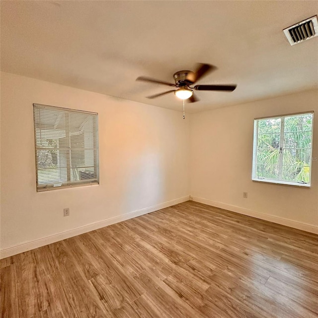 1615 NE 9th St, Ocala, FL 34470 - unfurnished room featuring wood finished floors, a ceiling fan, and baseboards
