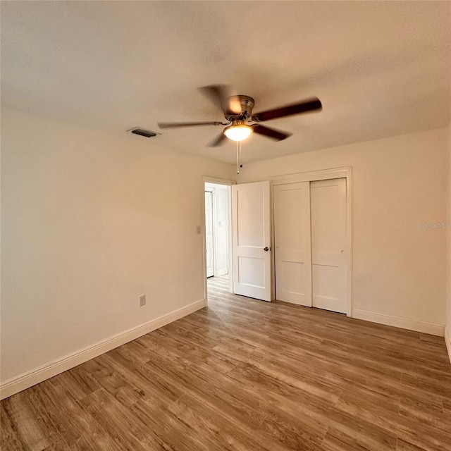1615 NE 9th St, Ocala, FL 34470 - unfurnished bedroom with wood finished floors, baseboards, and a closet