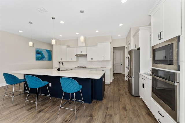 1598 Whitewood Ct, Kissimmee, FL 34747 - kitchen with appliances with stainless steel finishes, a sink, a large island, white cabinetry, and recessed lighting