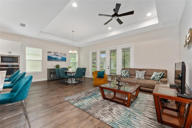1598 Whitewood Ct, Kissimmee, FL 34747 - living room with a tray ceiling, light wood-style floors, baseboards, a ceiling fan, and recessed lighting