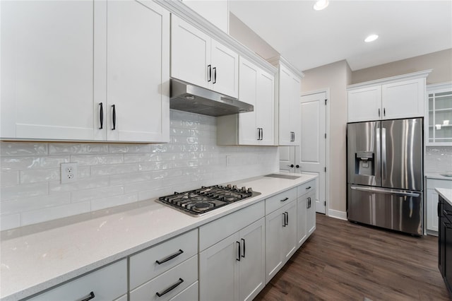 1598 Whitewood Ct, Kissimmee, FL 34747 - kitchen featuring stainless steel appliances, under cabinet range hood, white cabinets, decorative backsplash, and dark wood-type flooring