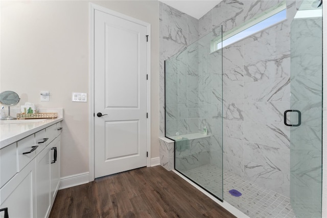 1598 Whitewood Ct, Kissimmee, FL 34747 - bathroom featuring a marble finish shower, wood finished floors, vanity, and baseboards