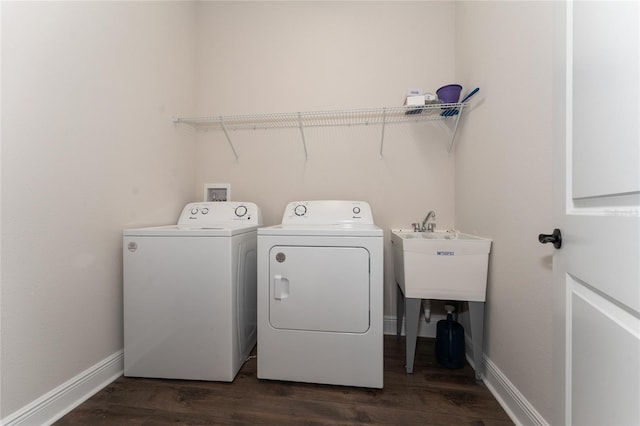 1598 Whitewood Ct, Kissimmee, FL 34747 - washroom with washing machine and clothes dryer, dark wood-style floors, and baseboards