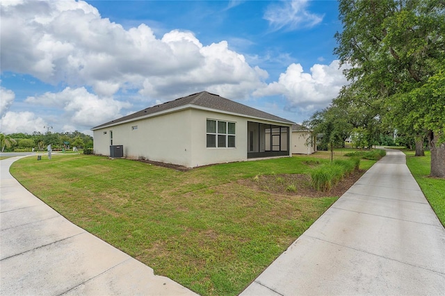 1598 Whitewood Ct, Kissimmee, FL 34747 - view of side of property with stucco siding, a lawn, central AC, and driveway