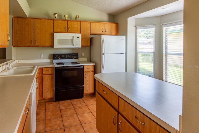 3267 Villa Way Cir, Saint Cloud, FL 34769 - kitchen featuring white appliances, a sink, a textured ceiling, light tile patterned floors, and lofted ceiling