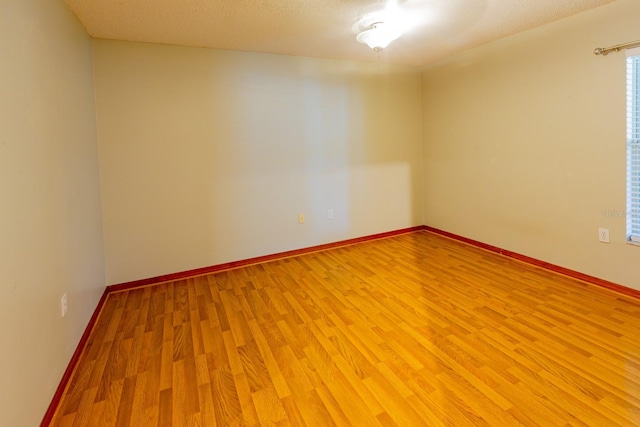 3267 Villa Way Cir, Saint Cloud, FL 34769 - spare room featuring light wood-style floors, baseboards, and a textured ceiling